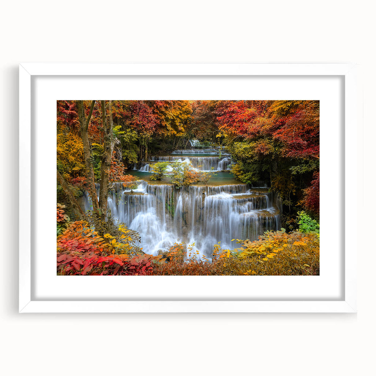Framed wall art featuring a serene waterfall landscape design, surrounded by a white mat and sleek frame, perfect for enhancing home decor with natural beauty.