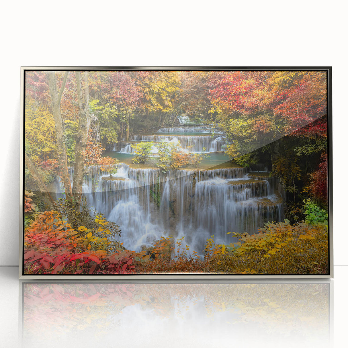 Framed wall art of a serene waterfall scene, featuring vibrant colors and intricate details, set in a sleek silver frame, perfect for enhancing home decor.