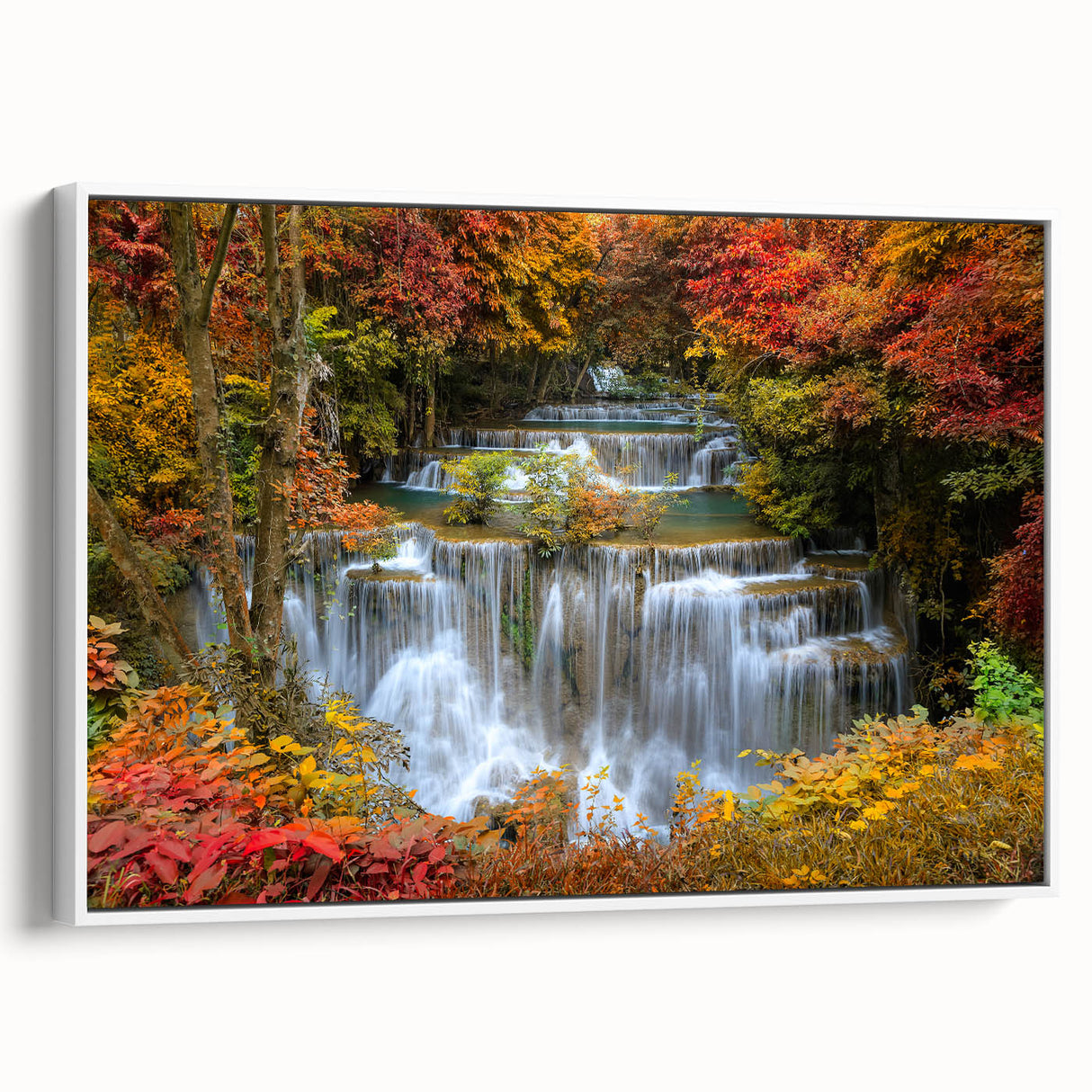 Framed canvas wall art depicting a serene waterfall landscape, featuring vibrant greens and blues, designed to enhance home decor with a calming nature theme.