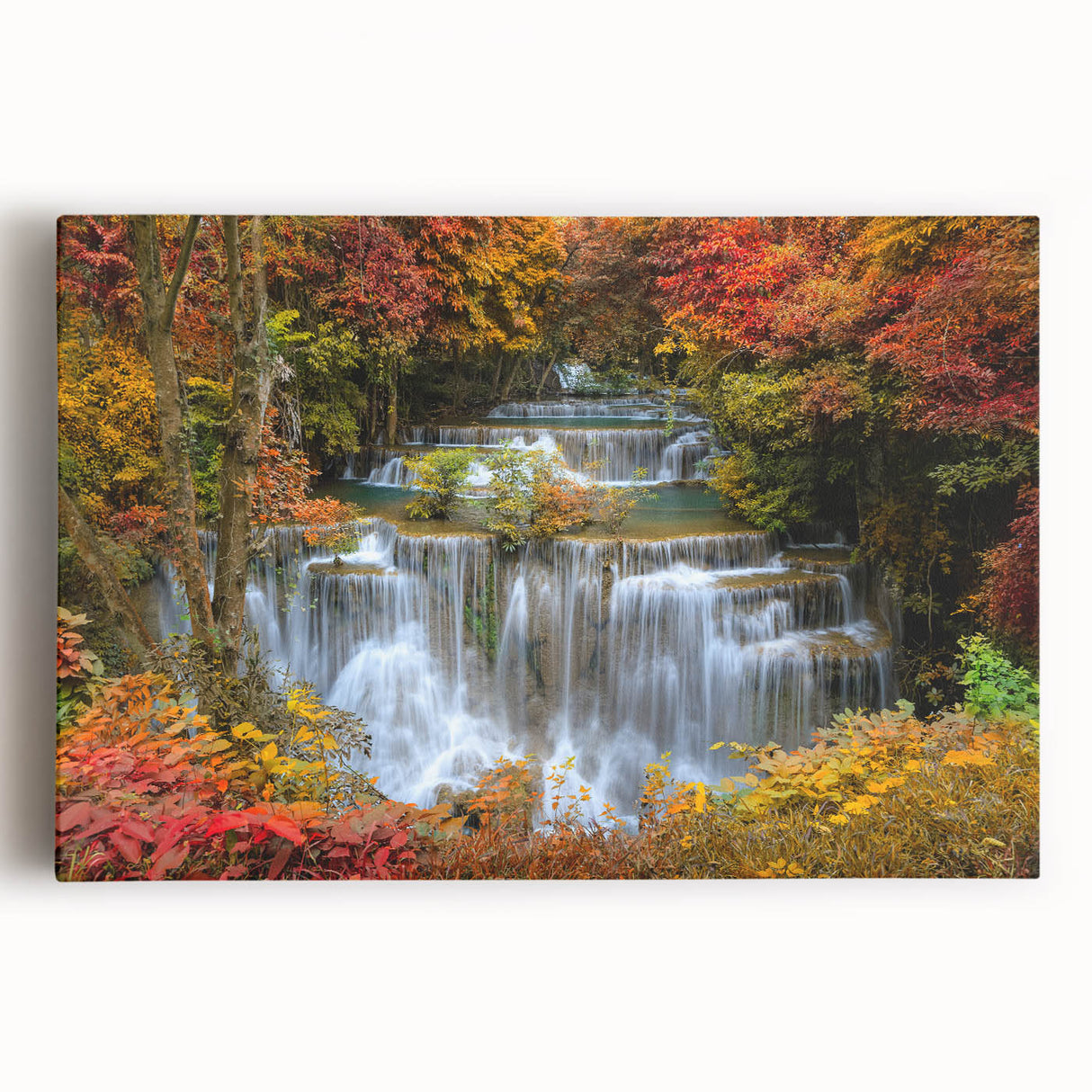 Stretched canvas wall art showcasing a serene waterfall landscape, featuring vibrant greens and tranquil blues, perfect for adding natural beauty to any space.