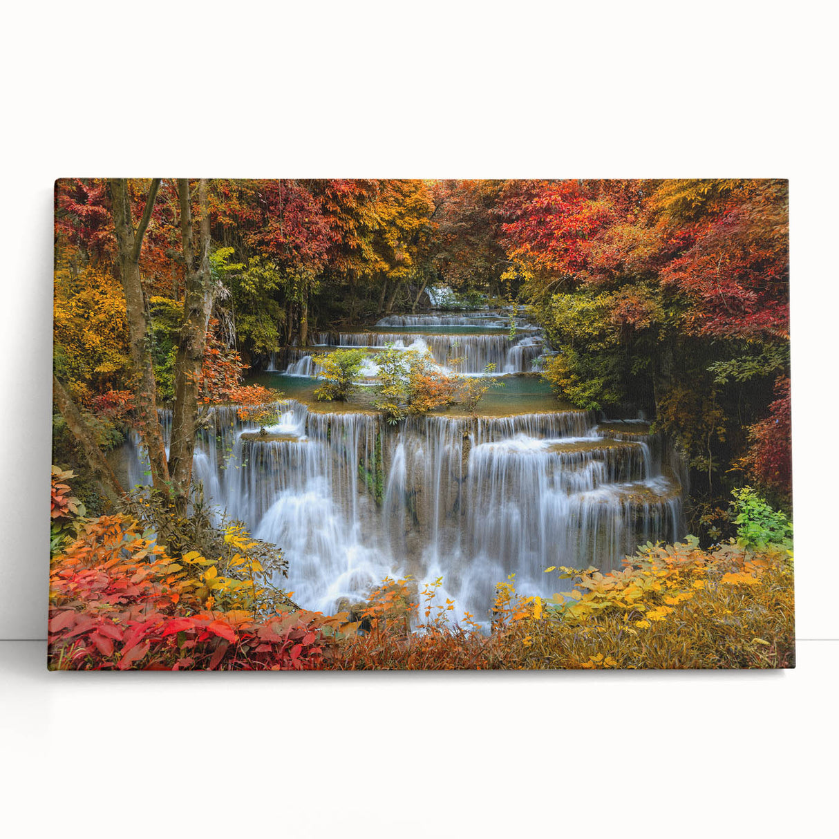 Stretched canvas wall art depicting a vibrant waterfall landscape with lush greenery, perfect for home decor. Ideal for nature enthusiasts seeking tranquility.