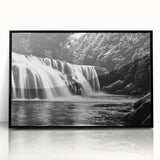 Framed acrylic wall art showcasing a stunning landscape of waterfalls, featuring vibrant blues and greens, with a sleek black frame, perfect for home decor.