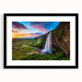 Framed wall art piece showcasing a stunning waterfall landscape in vibrant colors, featuring a matte black frame, ideal for enhancing home decor.