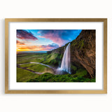 Framed wall art featuring a stunning waterfall landscape design, elegantly presented with a gold mat. Ideal for enhancing home decor with nature-inspired aesthetics.