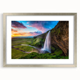 Framed landscape wall art featuring a serene waterfall scene, elegantly designed with a silver mat, perfect for enhancing home decor and creating a calming atmosphere.