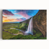 Stretched canvas wall art showcasing a vibrant landscape with cascading waterfalls, lush greenery, and soft blue skies, perfect for home decor enhancement.