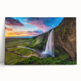 Stretched canvas wall art depicting a vibrant waterfall scene surrounded by lush greenery, showcasing rich blues and greens, perfect for home decor.