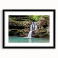 Framed wall art featuring a serene landscape of cascading waterfalls, presented in a sleek black frame with a white mat, perfect for home decor enhancement.