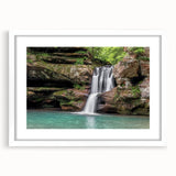 Framed wall art showcasing a serene waterfall landscape design, featuring vibrant blues and greens, with a white mat and sleek frame, perfect for home decor.