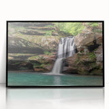 Framed acrylic wall art showcasing a stunning waterfall landscape design, featuring vibrant blues and greens, set in a sleek black frame for modern decor.