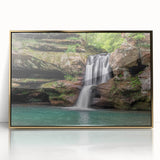 Framed wall art showcasing a serene waterfall landscape design with vibrant greens and blues, elegantly bordered in gold, perfect for nature-inspired decor.