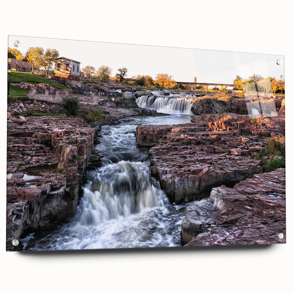 Acrylic glass wall art collection showcasing a stunning landscape of cascading waterfalls, featuring vibrant colors and intricate details, elegantly displayed with pins.