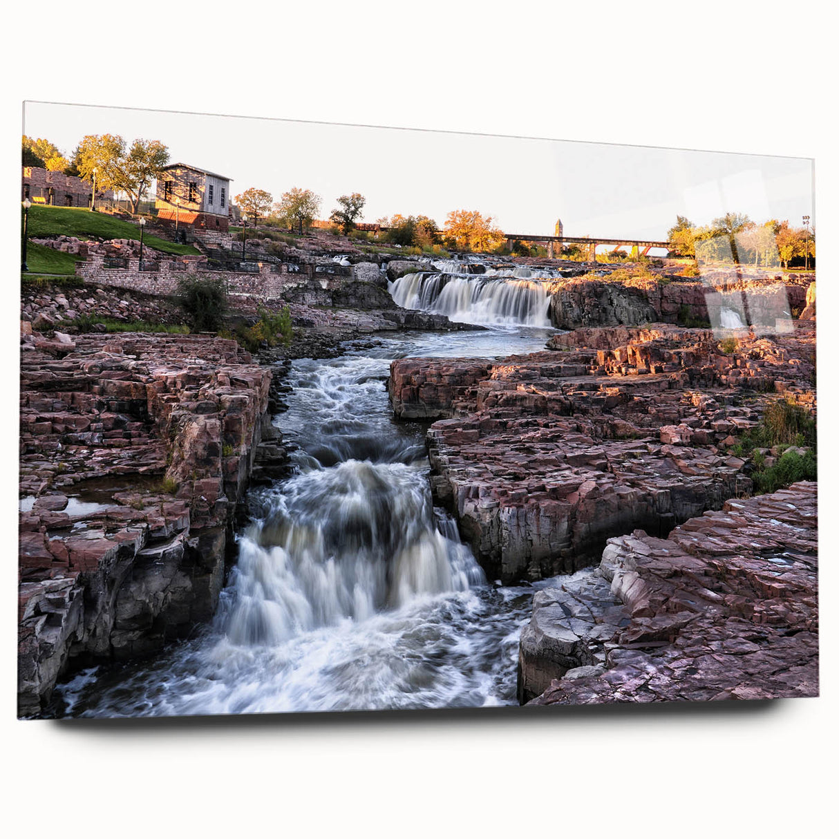 Acrylic wall art collection showcasing vibrant landscapes and cascading waterfalls, viewed from the side without pins, highlighting its sleek design and modern aesthetic.