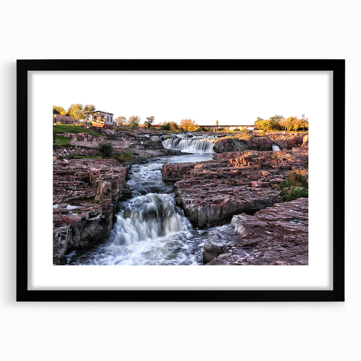 Framed black wall art featuring a serene landscape of cascading waterfalls, set against lush greenery, ideal for enhancing any modern home decor.