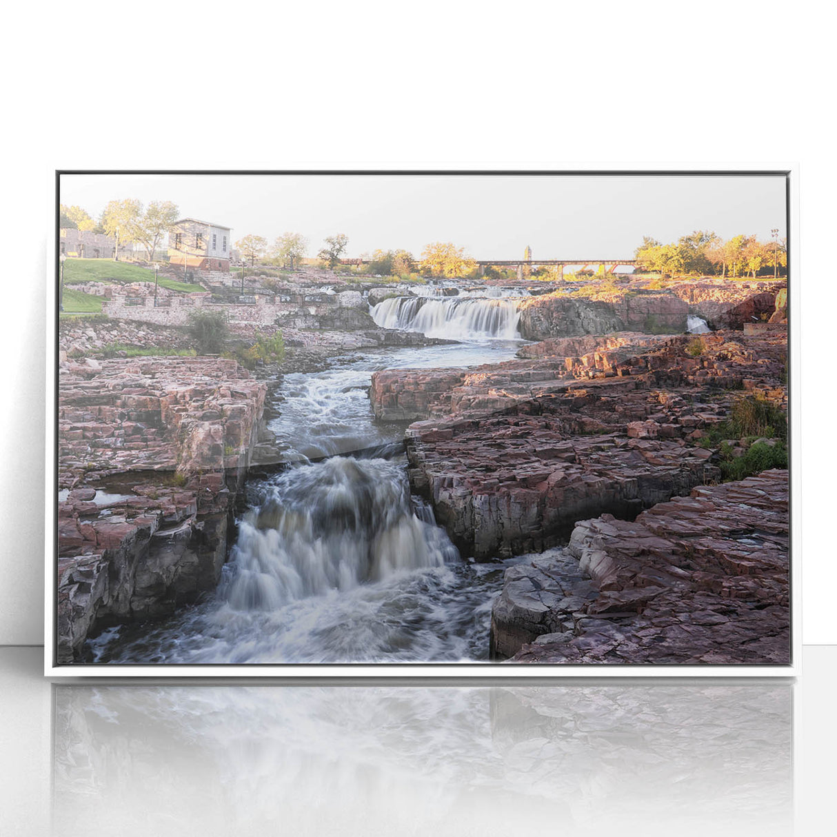 Framed acrylic wall art featuring a stunning waterfall landscape design in vibrant colors, displayed in a sleek white frame, ideal for modern home decor.