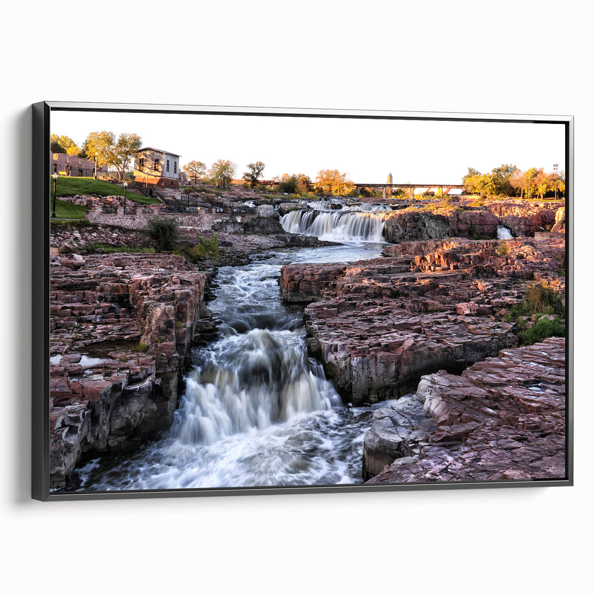Framed canvas wall art showcasing a breathtaking waterfall landscape design, featuring vibrant blues and greens, with a sleek black frame and side view perspective. Ideal for nature enthusiasts and home decor lovers, this piece adds a serene touch to any interior space.