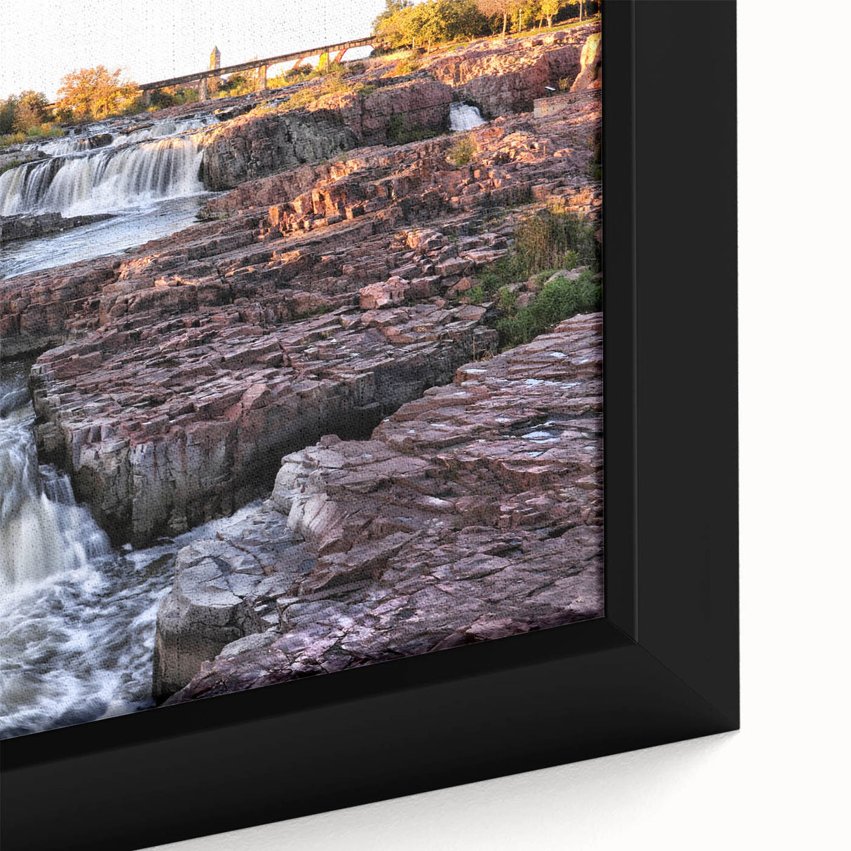 Framed canvas wall art showcasing a vibrant waterfall landscape with lush greenery, perfect for adding a serene touch to home decor. Ideal for nature enthusiasts.