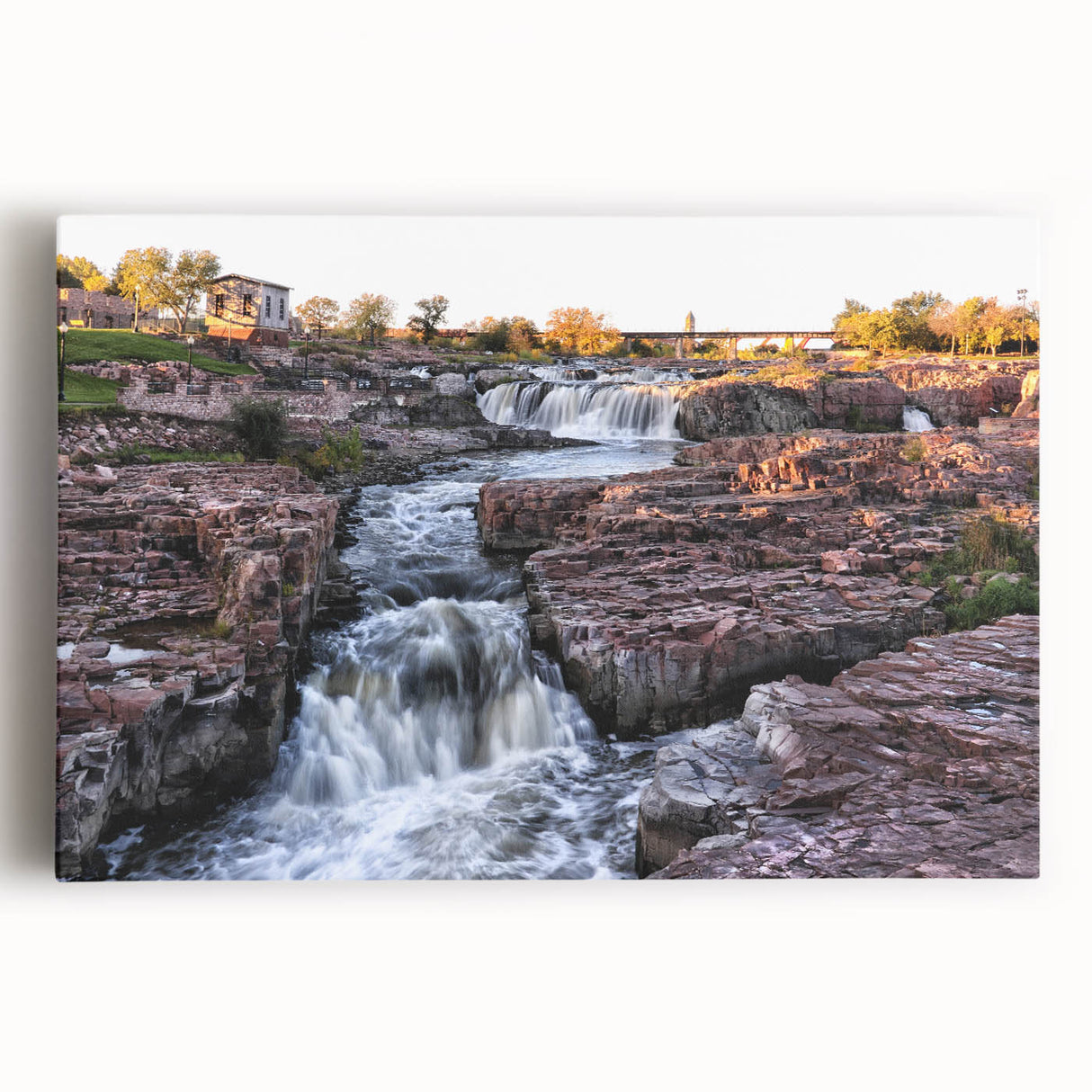 Stretched canvas wall art featuring a serene landscape with vibrant waterfalls and lush greenery, ideal for enhancing home decor and creating a tranquil atmosphere.