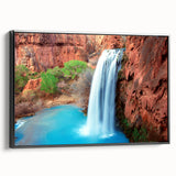 Framed canvas wall art showcasing a stunning waterfall landscape, featuring vibrant blue and green hues with a sleek black frame, perfect for home decor enhancement.