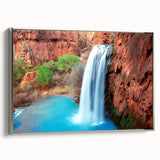 Framed canvas wall art showcasing a stunning waterfall landscape design, featuring vibrant blues and greens, elegantly bordered in silver, perfect for enhancing home decor.