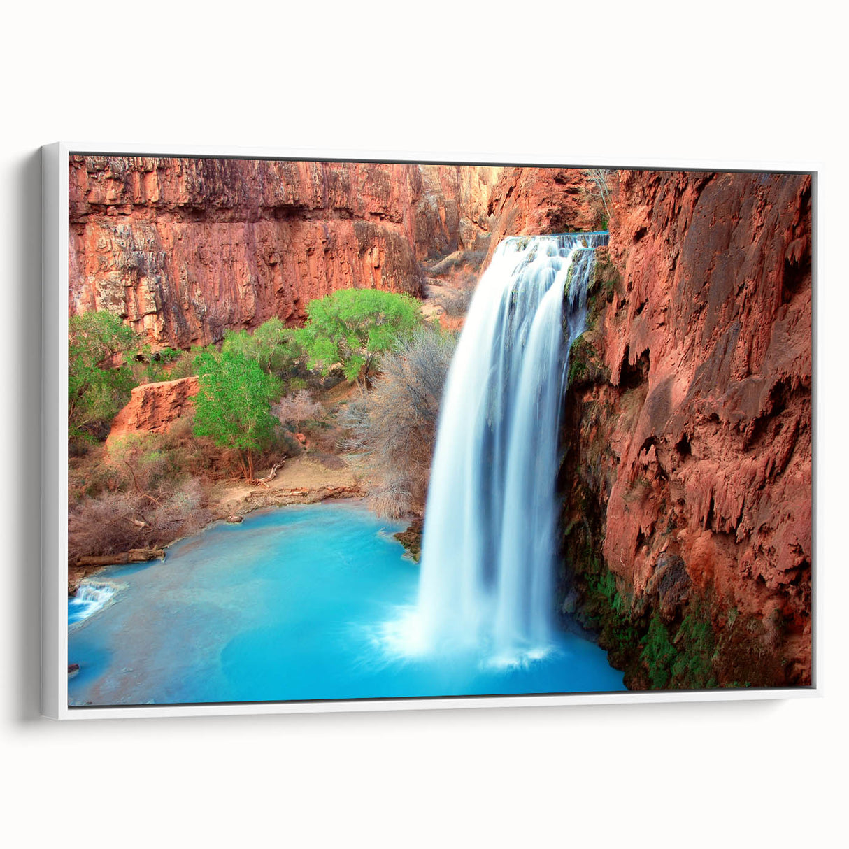Framed canvas wall art showcasing a serene waterfall landscape design in vibrant colors, displayed with a white frame, enhancing any home decor. Ideal for nature lovers.