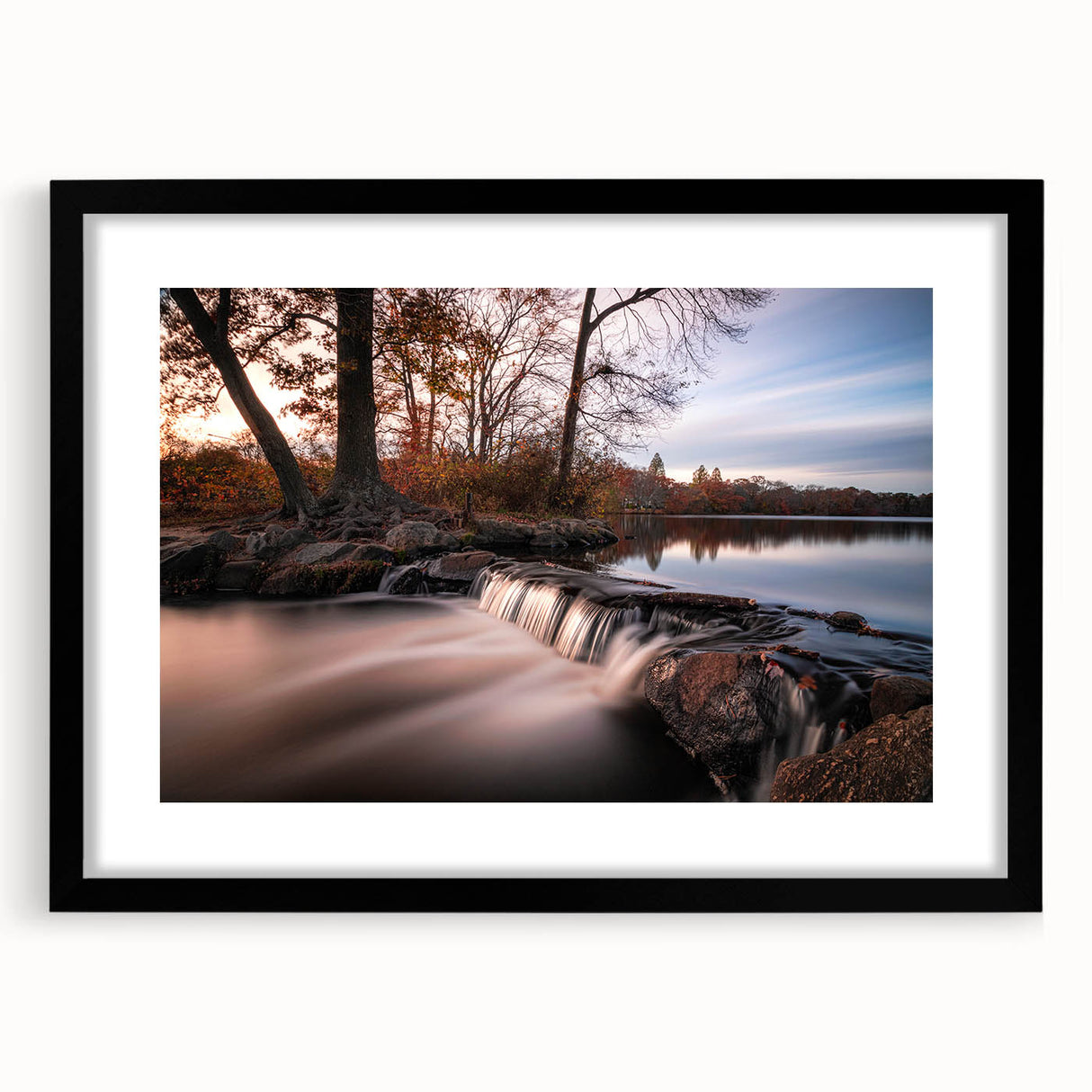 Framed wall art featuring a vibrant landscape of cascading waterfalls, set in a sleek black frame with a white mat, perfect for enhancing home decor.