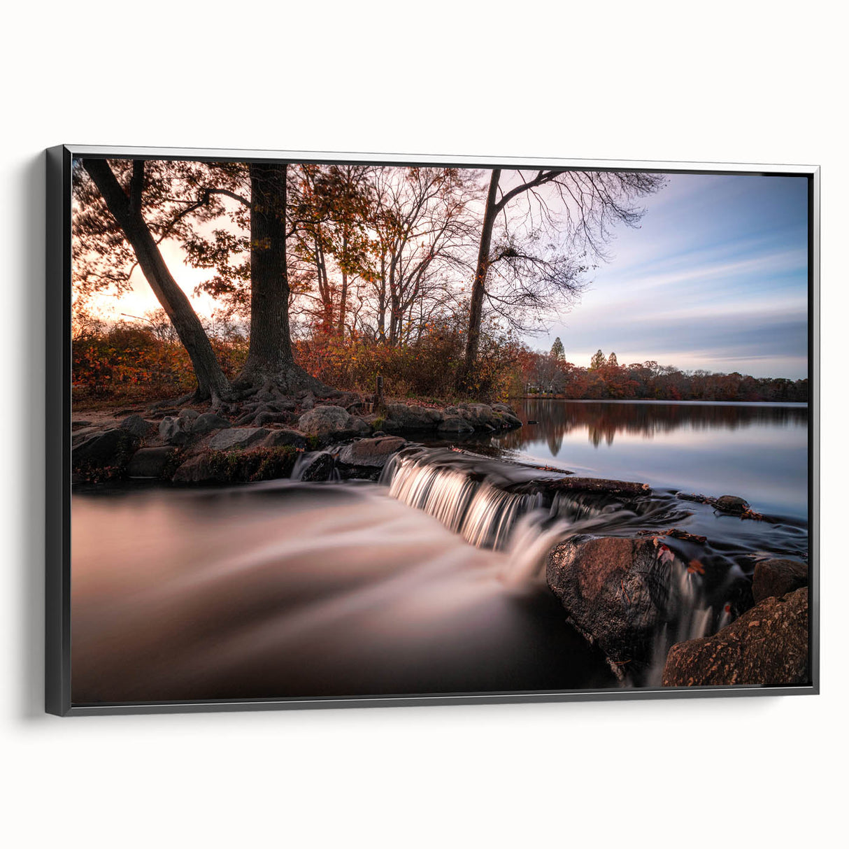 Framed canvas wall art featuring a serene waterfall landscape, showcasing vibrant blues and greens, with a sleek black frame enhancing the design. Perfect for home decor.