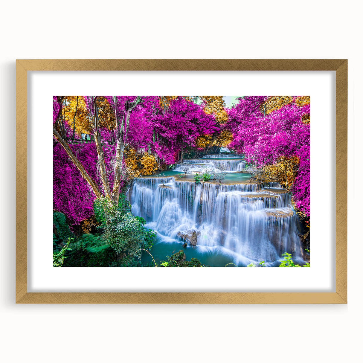 Framed wall art showcasing a serene waterfall landscape with vibrant colors, elegantly matted and finished with a gold frame, perfect for home decor.