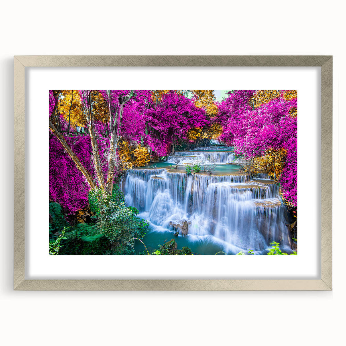 Framed landscape wall art featuring a serene waterfall design with vibrant greens and blues, accented by a sleek silver mat, ideal for home decor.