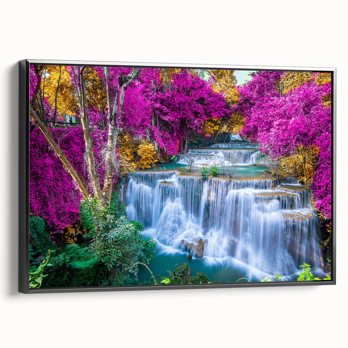 Framed canvas wall art showcasing a vibrant waterfall landscape design with lush greenery and flowing water, featuring a sleek black frame for modern decor.