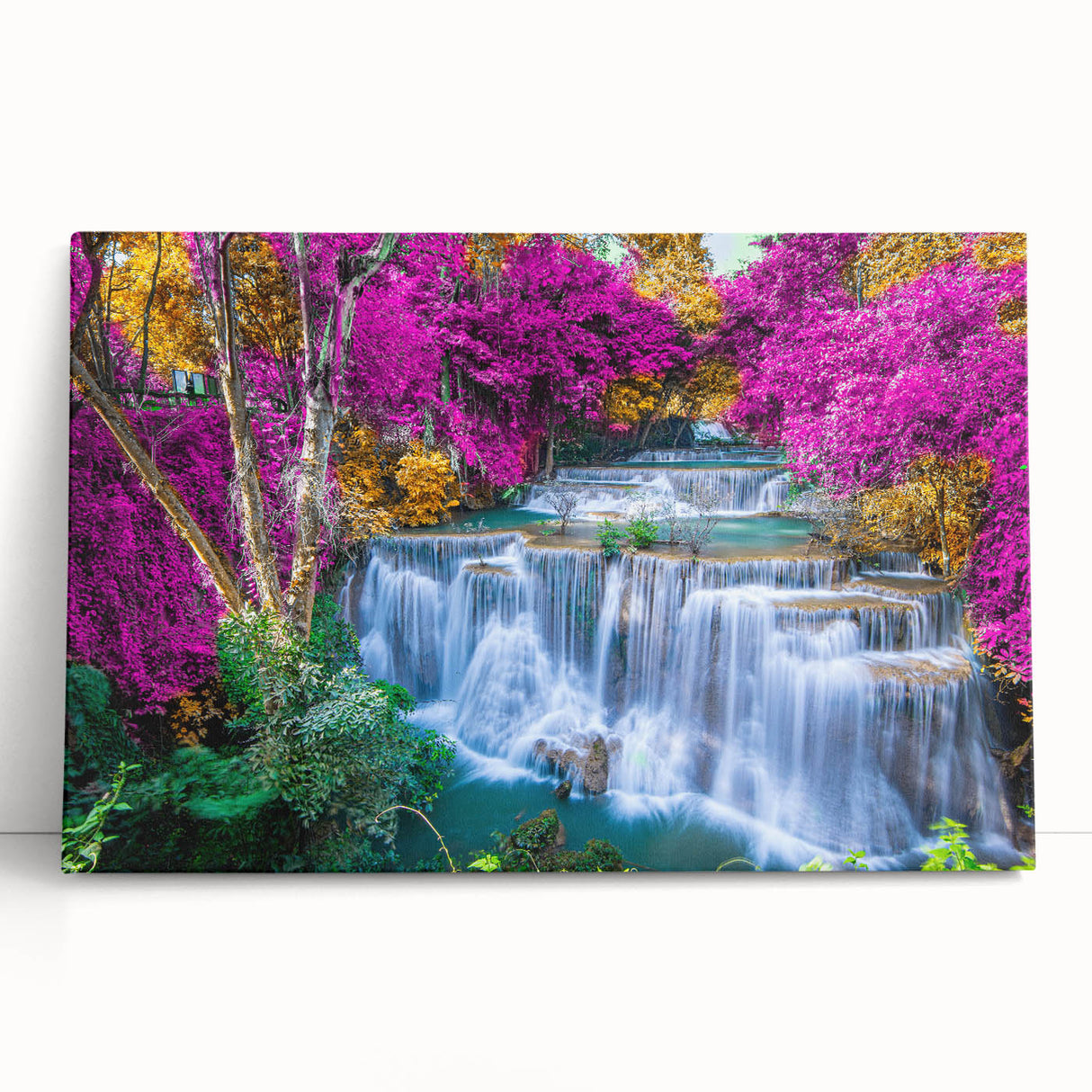 Stretched canvas wall art showcasing a serene waterfall landscape with vibrant green foliage and a clear blue sky, perfect for enhancing home decor.