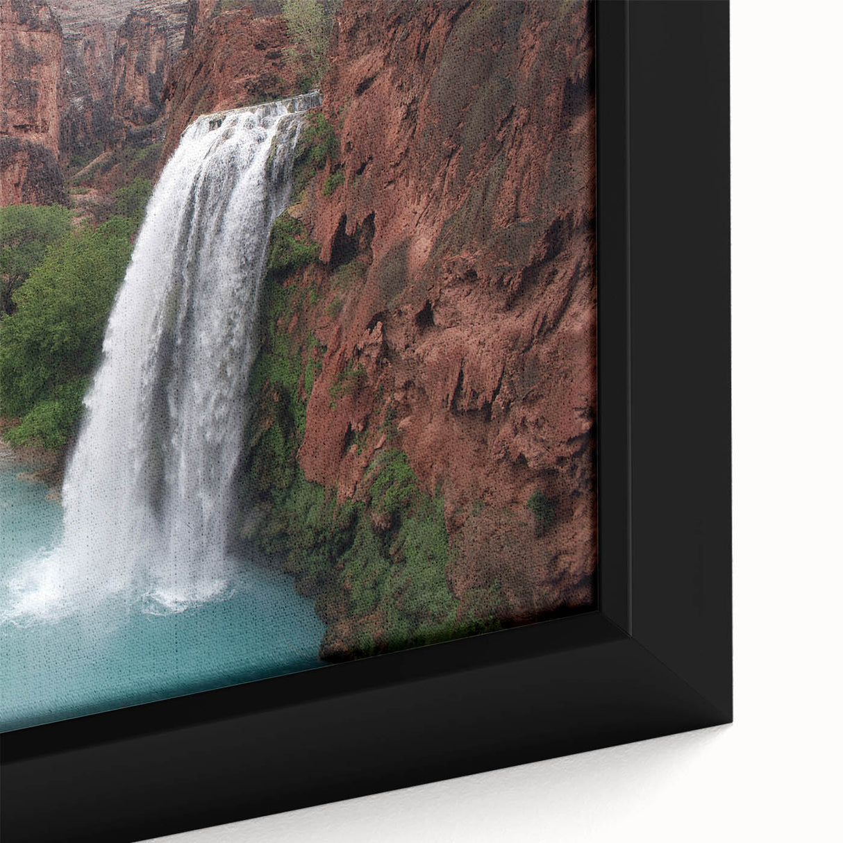 Framed canvas wall art showcasing a vibrant waterfall landscape with rich blues and greens, highlighting natural beauty and tranquility, perfect for home decor.