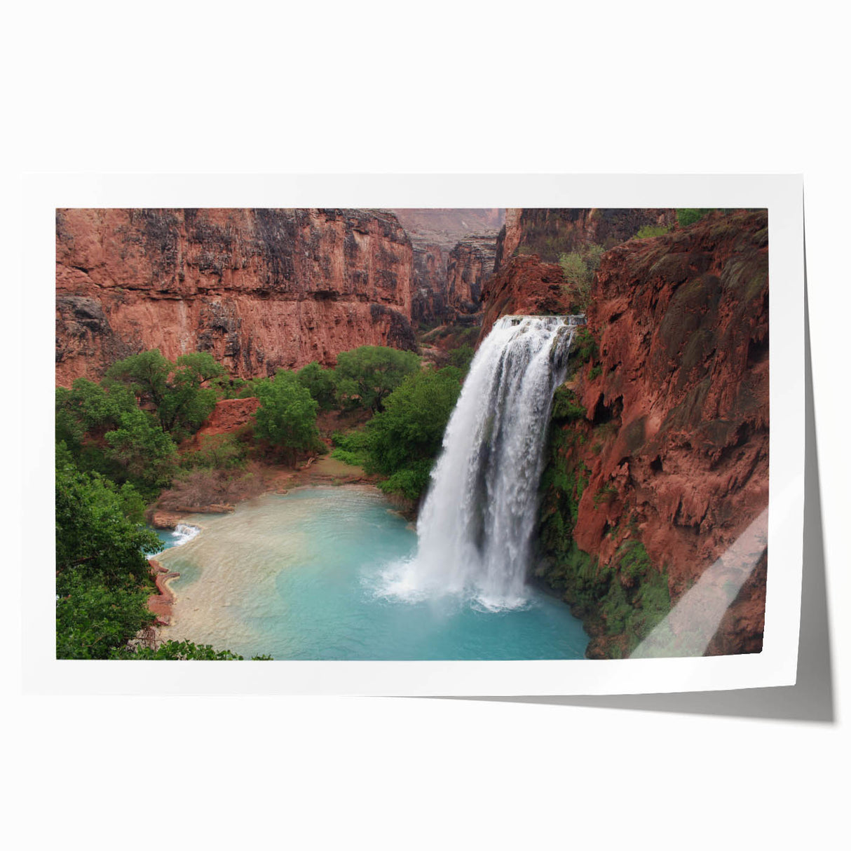 Stunning landscape wall art print featuring a serene waterfall cascading over rocks, surrounded by lush greenery, perfect for home decor and nature enthusiasts.