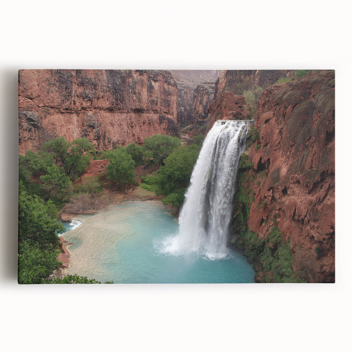 Stretched canvas wall art showcasing a vibrant waterfall landscape design in rich blues and greens, perfect for enhancing home decor with nature's beauty.