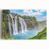 Stretched canvas artwork showcasing a vibrant landscape with a cascading waterfall surrounded by lush greenery, ideal for home decor and nature enthusiasts.