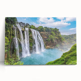 Stretched canvas artwork depicting a serene landscape with cascading waterfalls, lush greenery, and vibrant colors, ideal for home decor and nature enthusiasts.