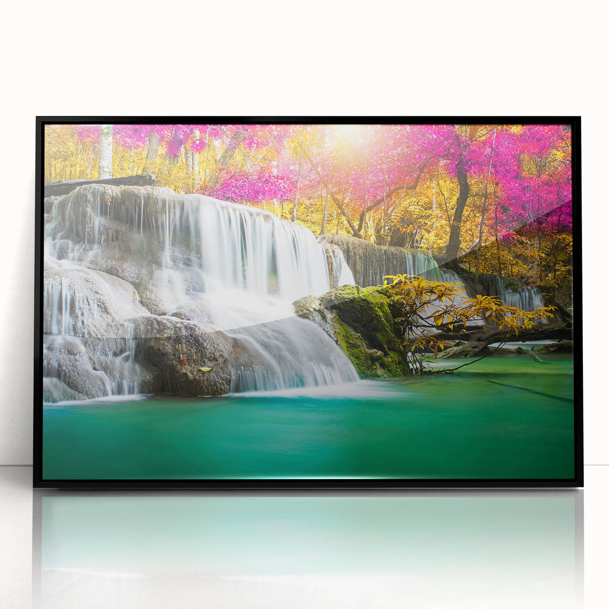 Framed acrylic wall art featuring a serene landscape with a cascading waterfall, surrounded by lush greenery, ideal for enhancing home decor with nature-inspired aesthetics.