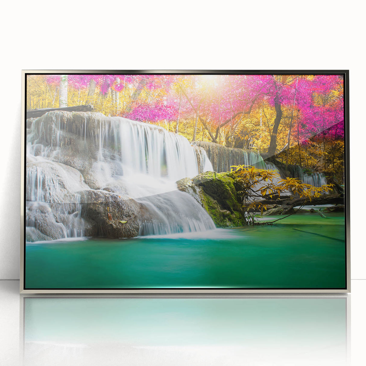 Framed acrylic wall art featuring a serene landscape of cascading waterfalls, enhanced with silver accents, perfect for modern home decor. This piece captures the tranquility of nature and adds an elegant touch to any interior space.