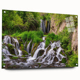 Acrylic glass wall art featuring a serene waterfall landscape design, displayed in a side view with visible mounting pins, perfect for home decor. The vibrant colors and intricate details enhance any space, making it an ideal choice for nature lovers.