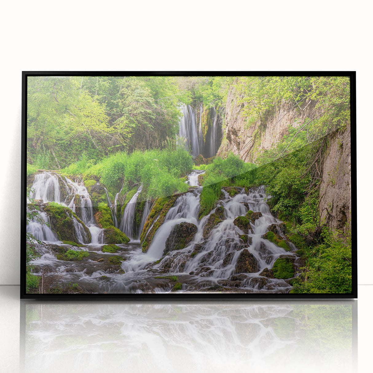 Framed acrylic wall art showcasing a vibrant waterfall landscape design in a black frame, perfect for enhancing home decor and adding a touch of nature.