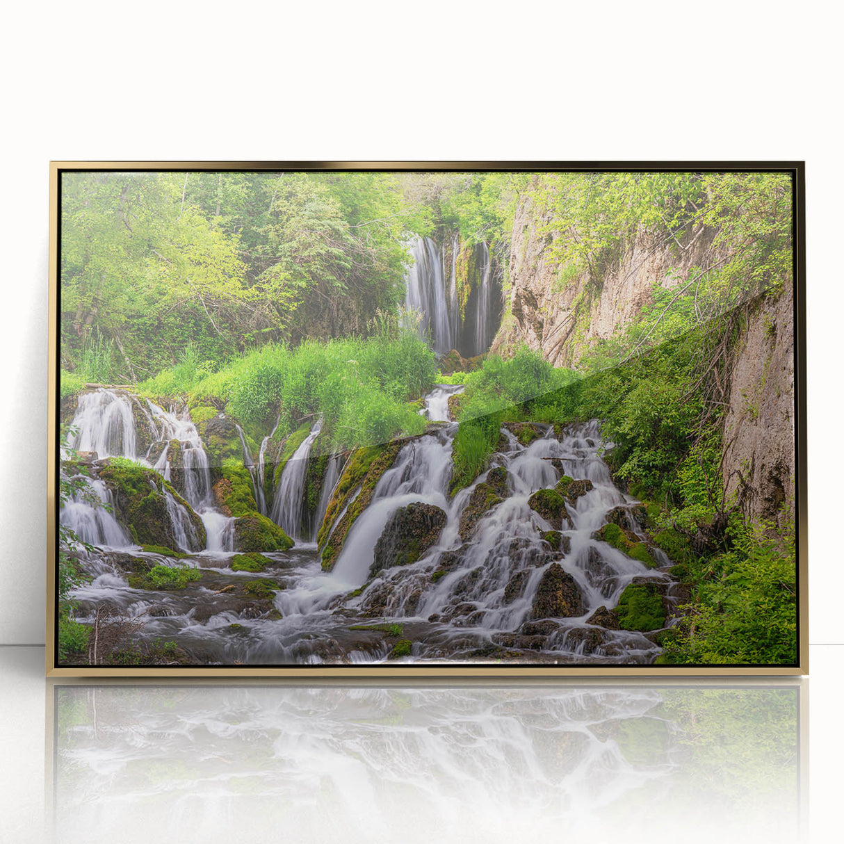 Framed acrylic wall art depicting a stunning waterfall landscape with vibrant colors and a gold frame, perfect for enhancing home decor aesthetics.