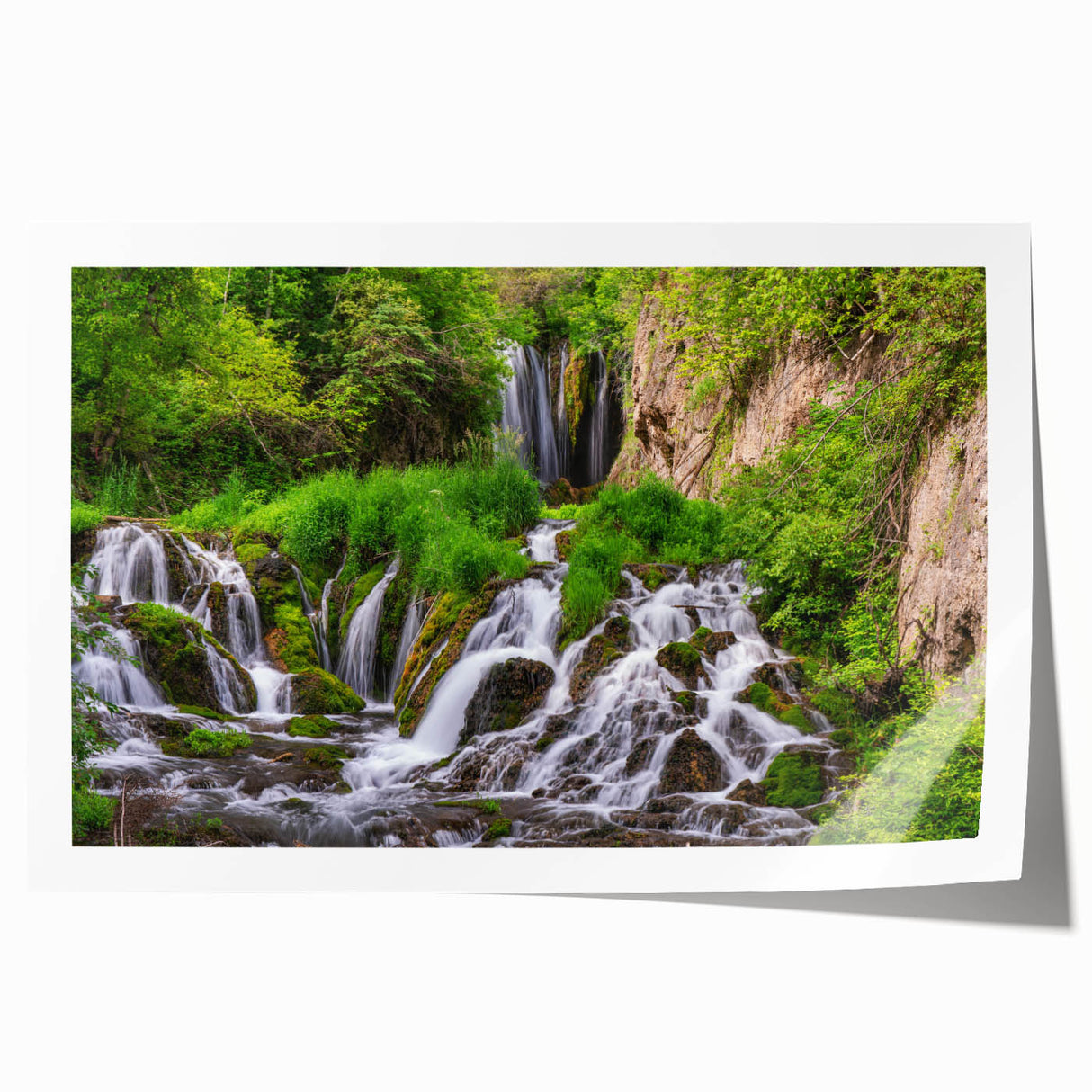 Serene landscape artwork depicting a vibrant waterfall cascading through lush greenery, ideal for home decor, printed on high-quality canvas for durability.