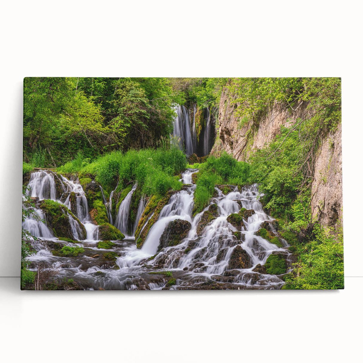 Stretched canvas art showcasing a vibrant waterfall landscape with lush greenery, perfect for home décor. Ideal for nature lovers seeking serene wall art.