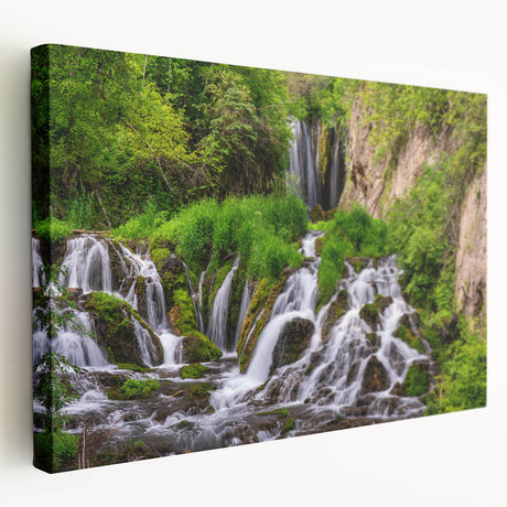 Stretched canvas wall art showcasing a vibrant waterfall landscape design with lush greenery and flowing water, perfect for home decor and nature enthusiasts.