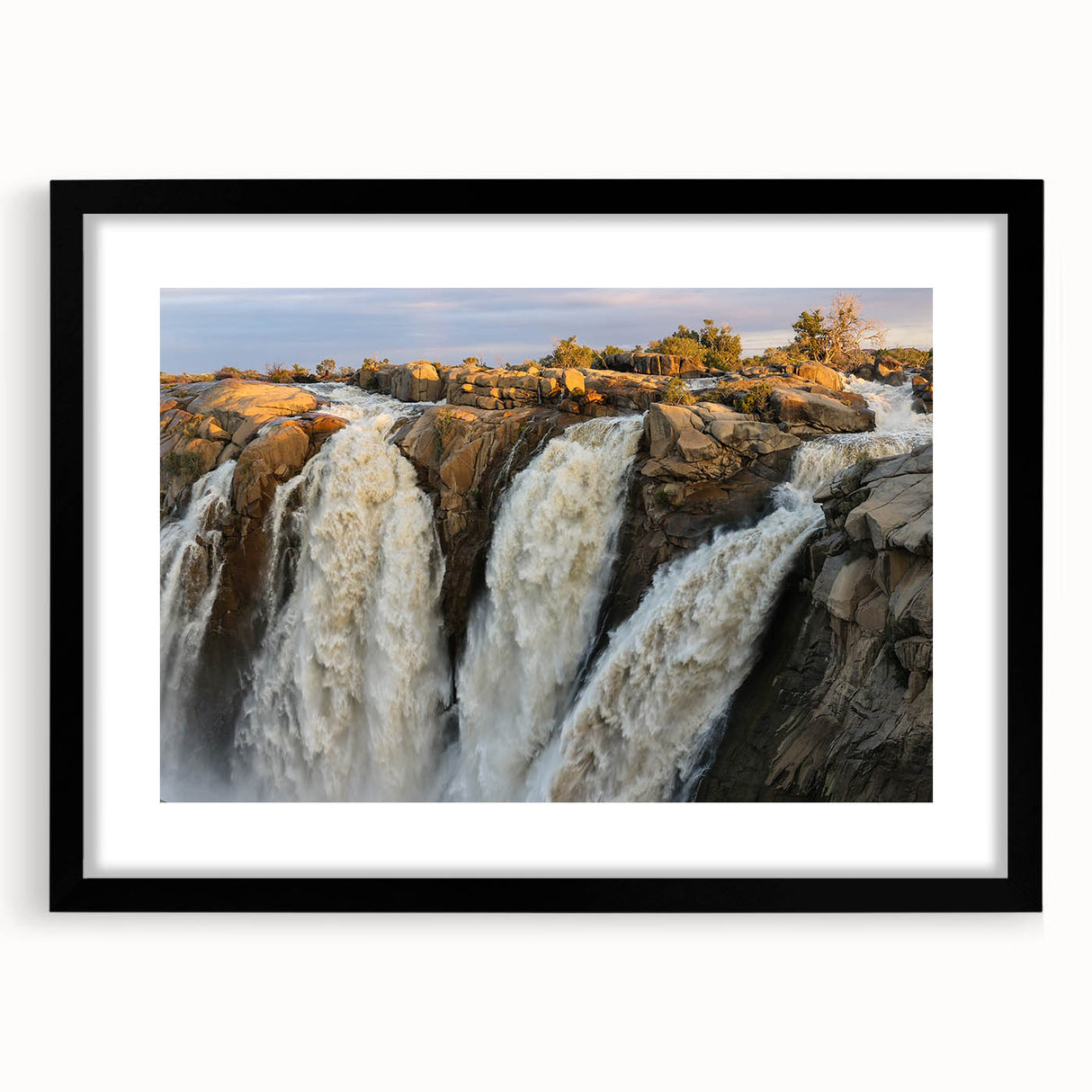 Framed wall art featuring a serene landscape with cascading waterfalls, set in a black frame with a mat, perfect for enhancing home decor.