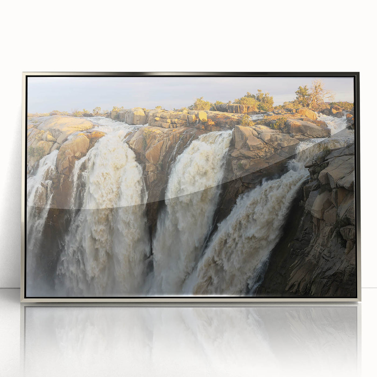Framed acrylic wall art featuring a serene waterfall design, set in a sleek silver frame. The artwork captures vibrant colors and intricate details, perfect for enhancing home decor. Ideal for nature lovers seeking to create a calming atmosphere in living spaces.