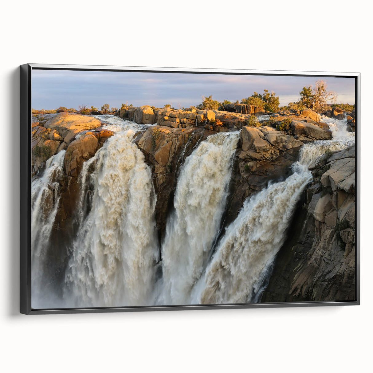 Framed canvas wall art showcasing a serene waterfall landscape design, featuring vibrant blues and greens, with a stylish black frame enhancing its elegance. Perfect for home decor or office settings.
