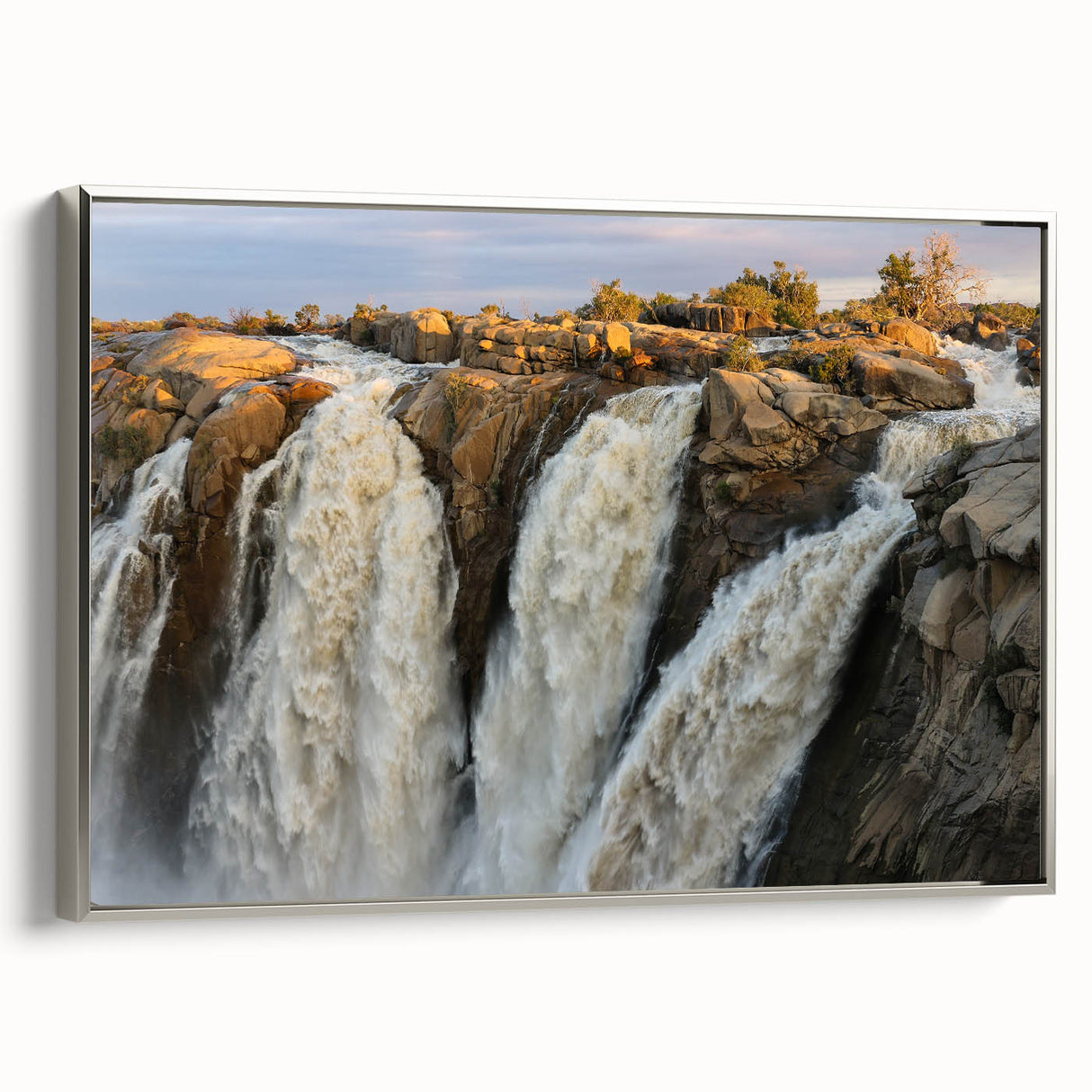 Framed canvas wall art featuring a serene waterfall landscape design with silver accents, showcased in a stylish side view, perfect for home decor.