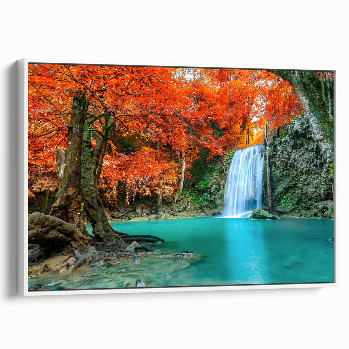 Framed canvas wall art depicting a serene waterfall landscape with vibrant greens and blues, elegantly showcased from a side view against a white background.