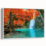 Framed canvas wall art depicting a serene waterfall landscape with vibrant greens and blues, elegantly showcased from a side view against a white background.